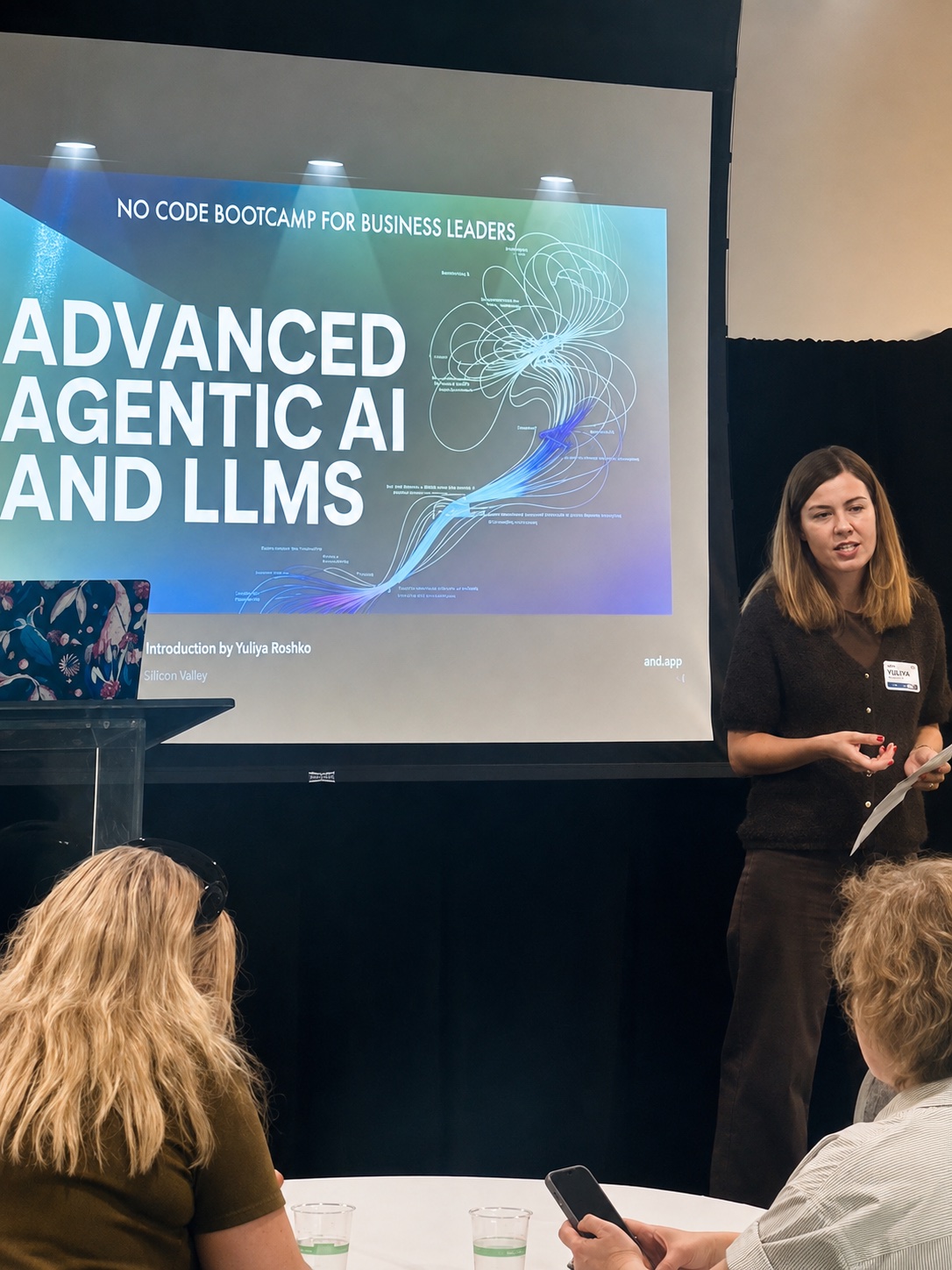 Yuliya Roshko opening the session in front of the title slide reading Advanced Agentic AI and LLMs.