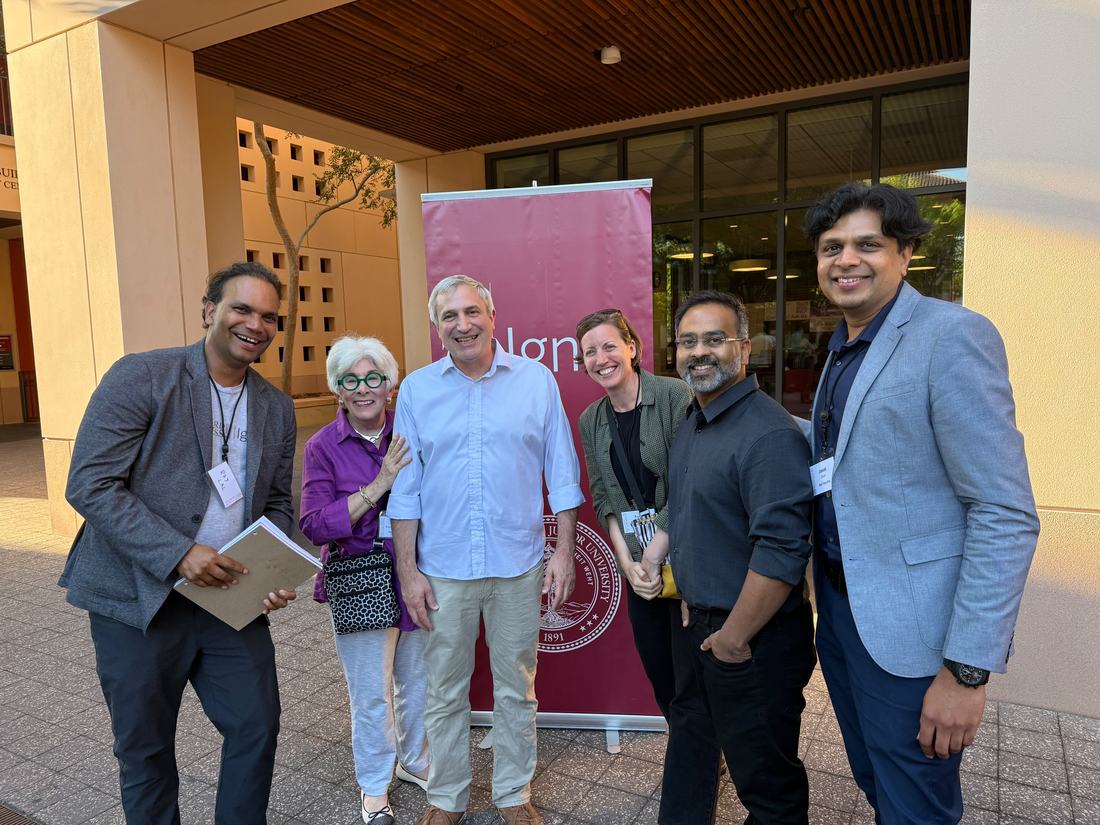 Raj Lal with Professor Yossi Feinberg and fellow Stanford Ignite alumni outside the reunion venue.